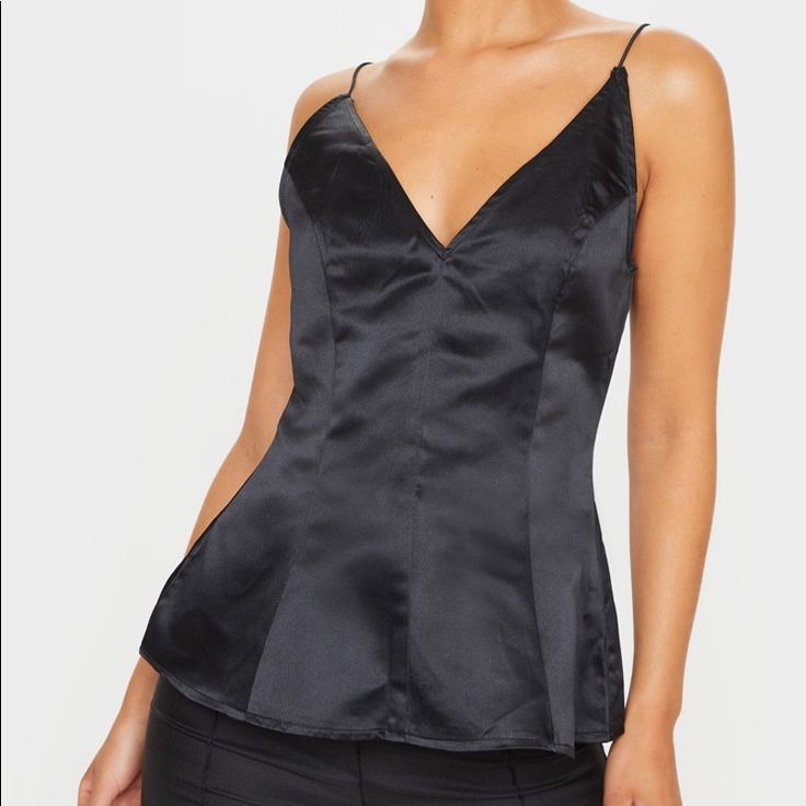 This Top Is Made With Satin Featuring A Cinched Waist And Peplum Hem. It Is Perfect To Wear For A Night Out Under A Blazer Or By Itself. Size 2 Brand New Never Worn With Tags On! Black Satin Camisole Top, Black Satin Tank Top For Evening, Black Satin Sleeveless Top, Black Satin Camisole For Summer, Black Satin Tank Top For Night Out, Black Satin Camisole For Night Out, Black Satin Tops For Date Night, Chic Black Satin Camisole, Black Satin Spaghetti Strap Tank Top