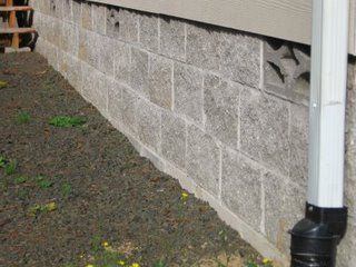 the side of a house that has been gutted and is being worked on with concrete