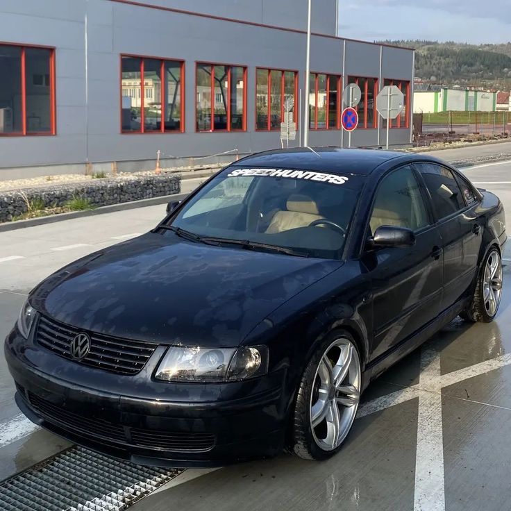 a black car parked in front of a building