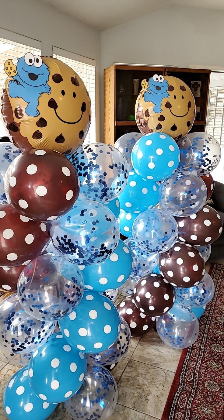 balloons are arranged in the shape of animals and polka dots on display at a party