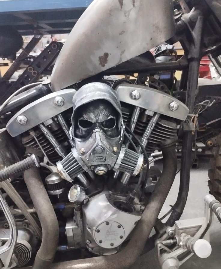 a close up of a motorcycle engine with a skull mask on it's head