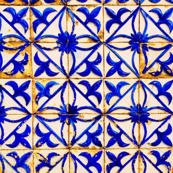 blue and white tiles with designs on them