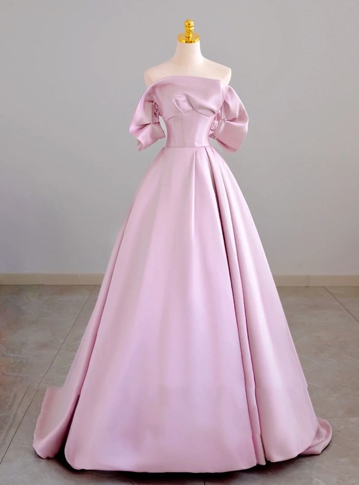 Qaulifying as a masterpiece of elegance, this prom dress features a harmonious blend of timeless beauty and modern sophistication. The soft pink color adds a touch of romance, while the off-shoulder neckline with structured sleeves introduces a contemporary twist. The bodice, expertly tailored, accentuates the waist before flowing into a voluminous skirt that ensures you make a grand entrance. The luxurious fabric and exquisite craftsmanship make this gown a standout choice for any formal event. Perfect for those who want to blend classic elegance with modern design, this dress promises to make your prom night truly magical. Embrace your unique style and grace with this stunning gown that is sure to leave a lasting impression. Grand Ball Gown, Dress Classy Elegant, Structured Sleeves, Blue Ball Gown, Dress With Puffy Sleeves, Spongebob Party, Voluminous Skirt, Satin Evening Gown, Blue Ball Gowns