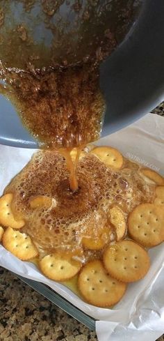 some crackers are being poured into a pan