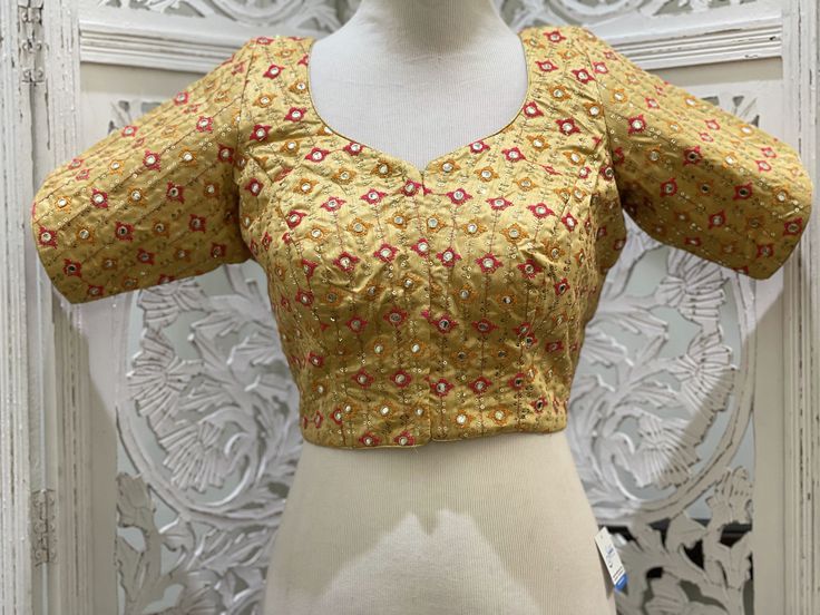 "Gold blouse with zari thread work embroidered motifs enhanced with back dori and gold border. Material:Dupion Silk Size 38\": The blouse comes with an added allowance and it can be altered to a standard size of 34\"-42\" on request. Size 42\": The blouse comes with an added allowance and it can be altered to a standard size of 34\"-44\" on request. Occasion: Wedding Wear, Traditional Wear, Festive Wear,Designer Blouse,embroidered blouse,Custom Wear Blouse,Readymade blouse. Note: Colors may slig Stretchable Blouse, Embroidered Kurti, Embroidered Motifs, Gold Blouse, Wedding Blouse, Dupion Silk, Blouse Price, Gold Border, Readymade Blouse