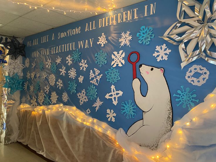 there is a polar bear holding a key in front of a bulletin board with snowflakes on it