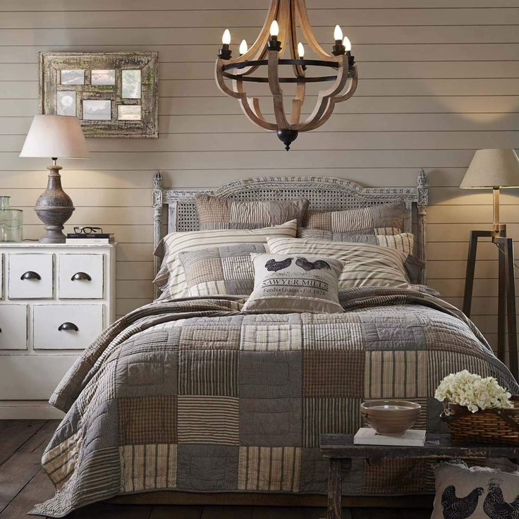 a bed room with a neatly made bed and a chandelier hanging from the ceiling