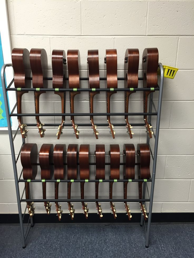 a rack with lots of brown cups on top of it in front of a wall