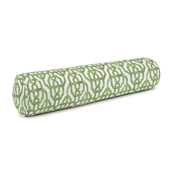 a roll of green and white fabric with an intricate design on the top, in front of a white background