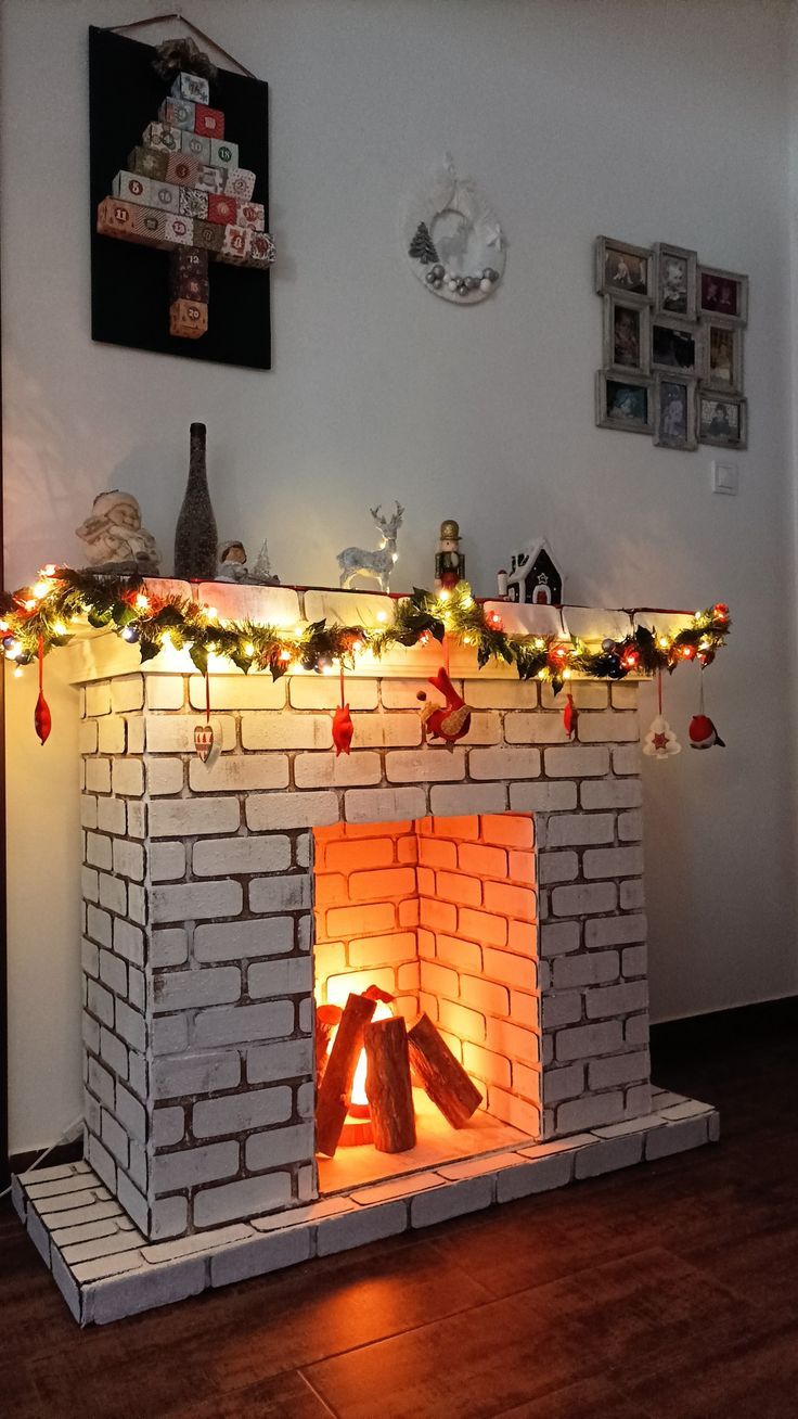 a brick fireplace with christmas lights on it