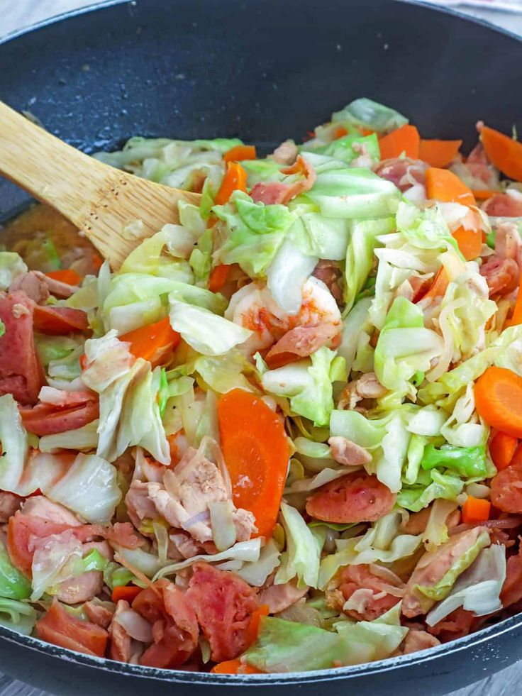 a pan filled with chopped vegetables and meat