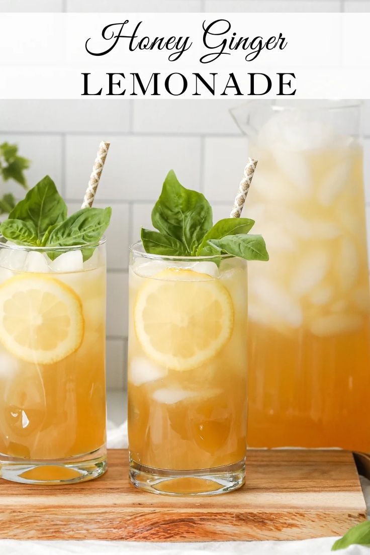 two glasses filled with lemonade on top of a cutting board