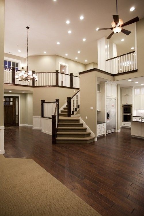 a large open floor plan with stairs leading up to the second story