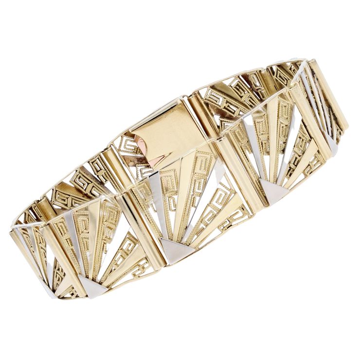 Bracelet in 18 karat yellow and white gold, eagle and rhinoceros heads hallmark. Taking up the characteristic patterns of its time, this Art Deco bracelet is formed of a suite of 10 rectangular patterns articulated between them and decorated with patterns representing Greeks in filigree and a pattern in fan in white gold alternated with yellow gold. The ratchet clasp with safety "8" is hidden in the pattern. Length : 18.5 cm approximately, width : 15 mm, thickness : 2.3 mm approximately, inner circumference : 18 cm approximately. Total weight of the jewel : 26,9 g approximately. Authentic antique jewel - French work of the years 1925. Our opinion : a magnificent and rare Art Deco bracelet. Specialized in antique and creation jewelry since 1975, we deliver all our jewel with their certifica Bracelet Art, Art Deco Bracelet, Gold Eagle, Antique Bracelets, White Gold Bracelet, Gold Art Deco, Retro Jewelry, Gold Art, Dream Ring