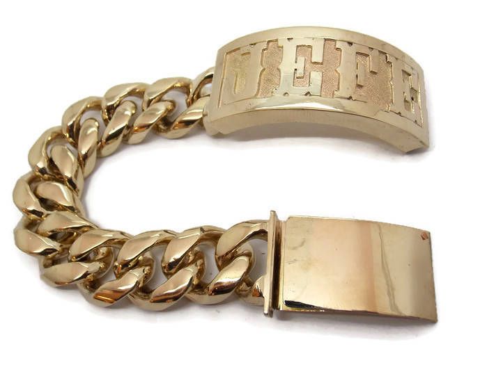 10K SOLID YELLOW GOLD BRACELET CUBAN LINK. WITH NAME(UP TO SEVEN LETTERS). OF 10K SOLID GOLD. WE HAVE BEEN IN THE JEWELRY BUSINESS FOR OVER 35 YEARS. WE DO CUSTOM WORK TO OUR CLIENTS WISHES. THIS EXQUISITE BRACELET IS MANUFACTURED BY US HERE IN THE USA. WITH A 100% SATISFACTION GUARANTEE OR YOUR MONEY BACK. IF ANY QUESTIONS FEEL FREE TO ASK! APPROXIMATE WEIGHT 7 INCH: 200 GRAMS 8 INCH: 225 GRAMS 9 INCH: 250 GRAMS We will be glad to help. Luxury Gold Name Bracelet Tarnish Resistant, Luxury Gold Tarnish-resistant Name Bracelet, Luxury Gold Bangle Name Bracelet, Designer Gold Bracelet With Jubilee Band, Gold Nameplate Bracelet With Polished Finish, Designer Gold Bracelets With Jubilee Bracelet, Designer Gold Bracelets With Jubilee Style, Luxury Gold Hallmarked Bracelet, Luxury Gold Name Bracelet