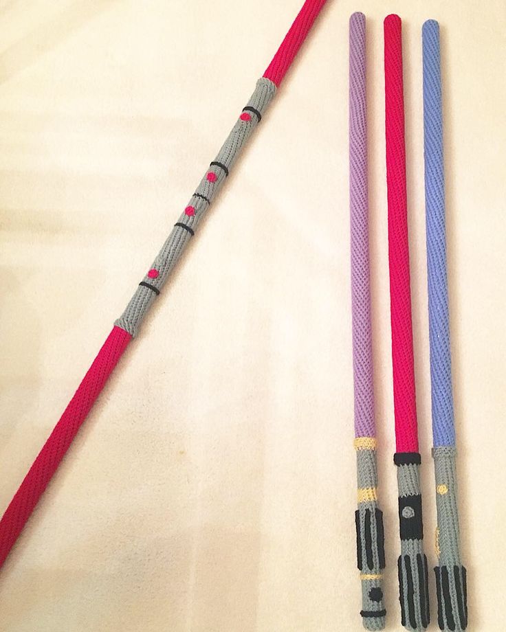 three different types of umbrellas on a white tablecloth with red, purple and blue handles