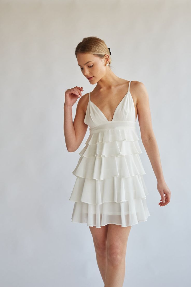 front view white v neck tiered ruffle mini dress with spaghetti straps - white-image | graduation mini dress | sorority rush dress | bride to be white mini dress for bridal shower What To Wear For Graduation, White Grad Dresses, White Mini Dresses, Dresses For Graduation, Dainty Accessories, Tiered Ruffle Mini Dress, Beautiful Mini Dresses, White Bridal Dresses, Tiered Ruffle Skirt