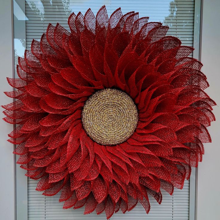 a large red flower on the side of a door