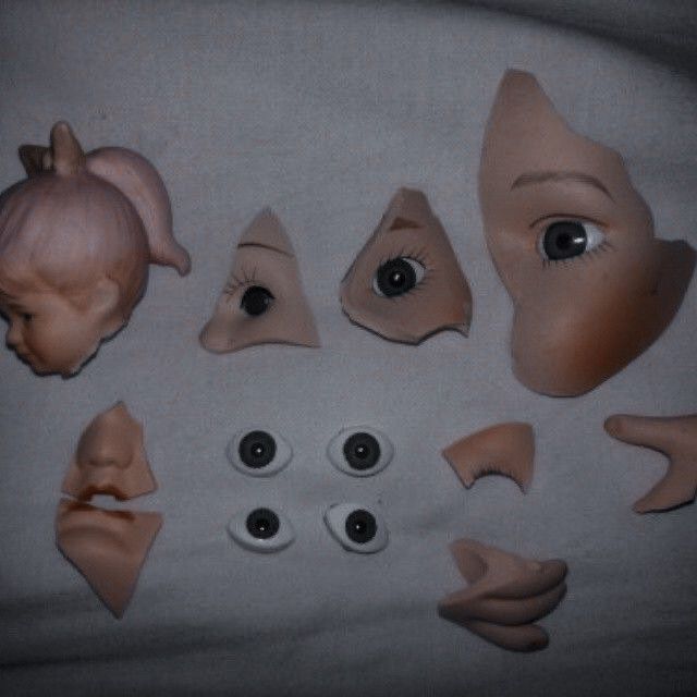 a group of doll heads with eyes and nose shapes