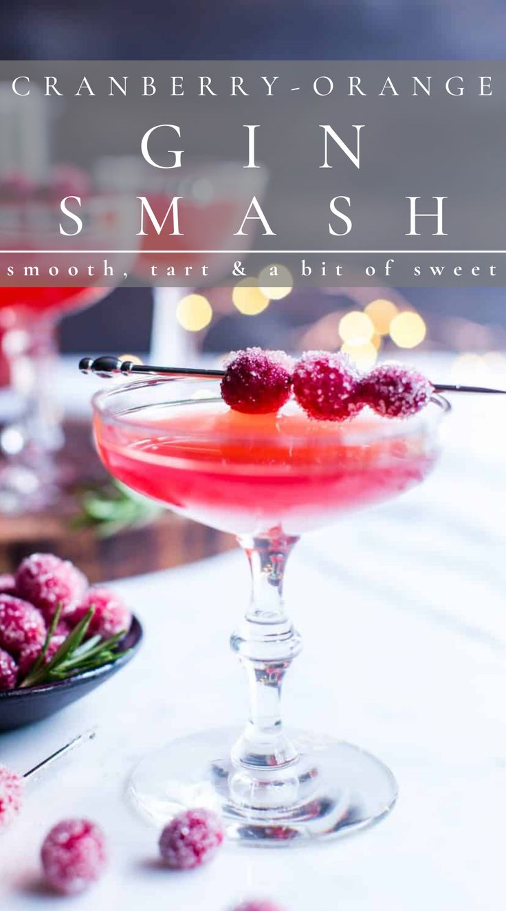 the cranberry gin smash cocktail is garnished with raspberries