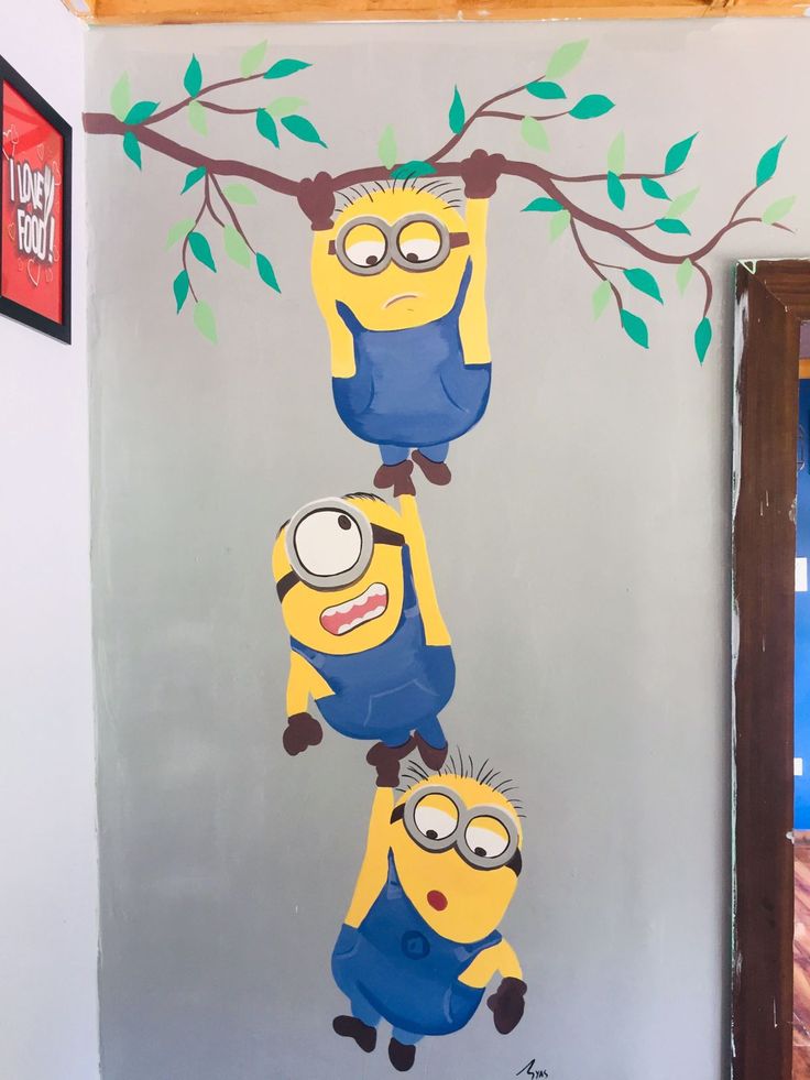 a wall with three cartoon characters hanging from it's branches, painted in yellow and blue