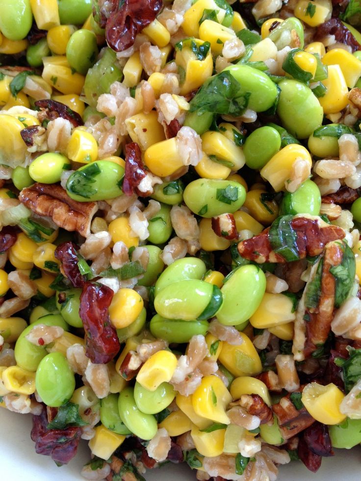 a white bowl filled with mixed vegetables and grains