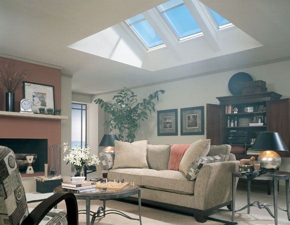 a living room filled with furniture and a skylight