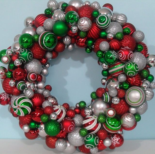 a christmas wreath with ornaments hanging from it