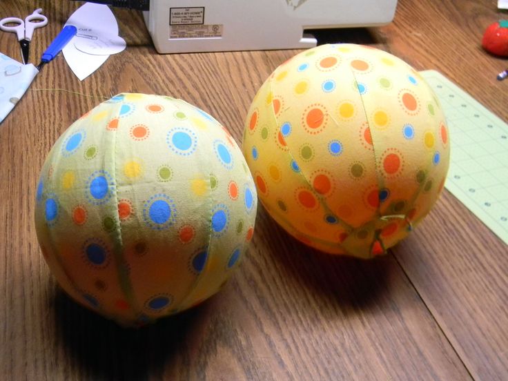 two balls sitting on top of a wooden table