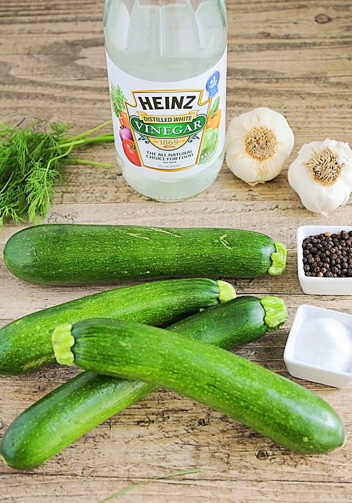 cucumbers, garlic, and seasoning on a wooden table