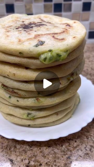 a stack of flatbreads sitting on top of a white plate