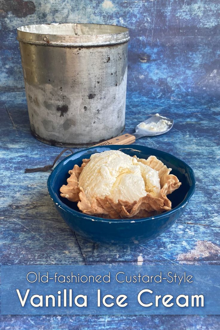 old fashioned custard style vanilla ice cream in a blue bowl next to an ice bucket