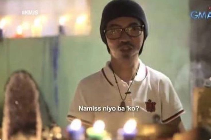 a man wearing glasses and a hat standing in front of candles with the caption namiss niyo ba ko?