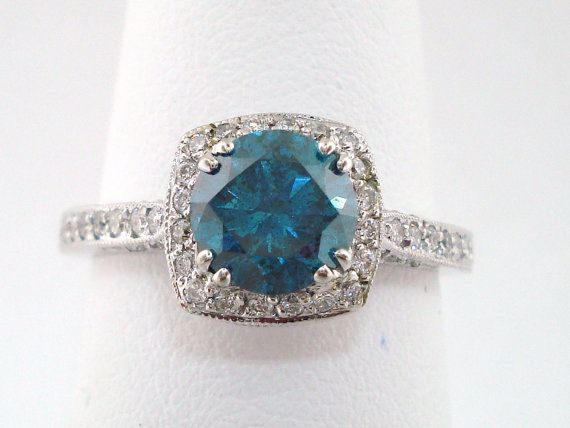 a blue and white diamond ring sitting on top of a napkin