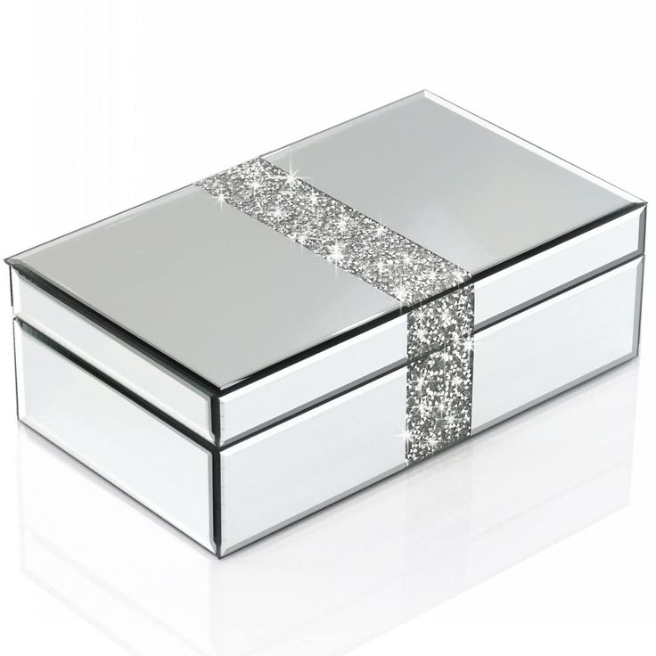 a white box with silver sequins on the lid and sides, sitting on a white surface