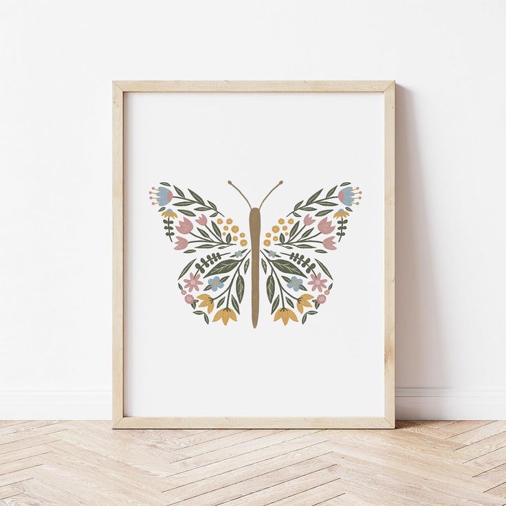 an art print of a butterfly with colorful flowers on it's wings is displayed in a wooden frame