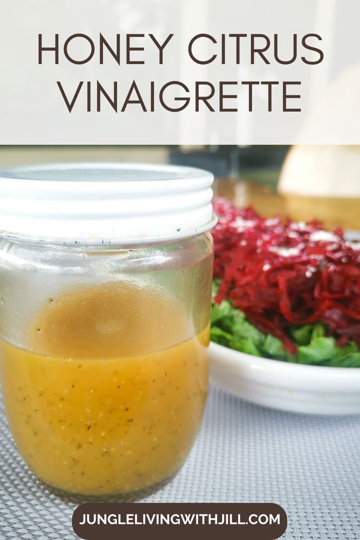 honey citrus vinaigrette in a jar next to a salad