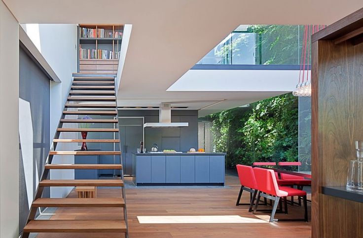 an open floor plan with stairs leading up to the dining room and kitchen area in this modern home