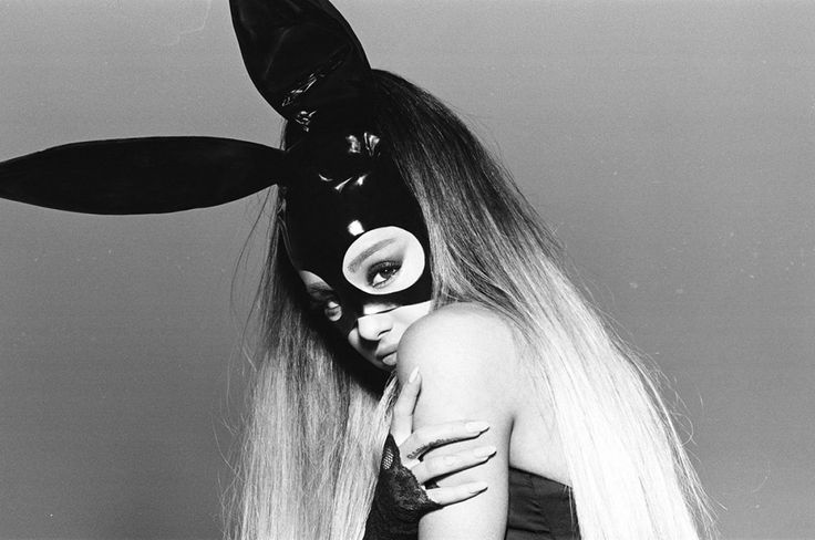 a woman with long hair and bunny ears on her head is wearing a black mask