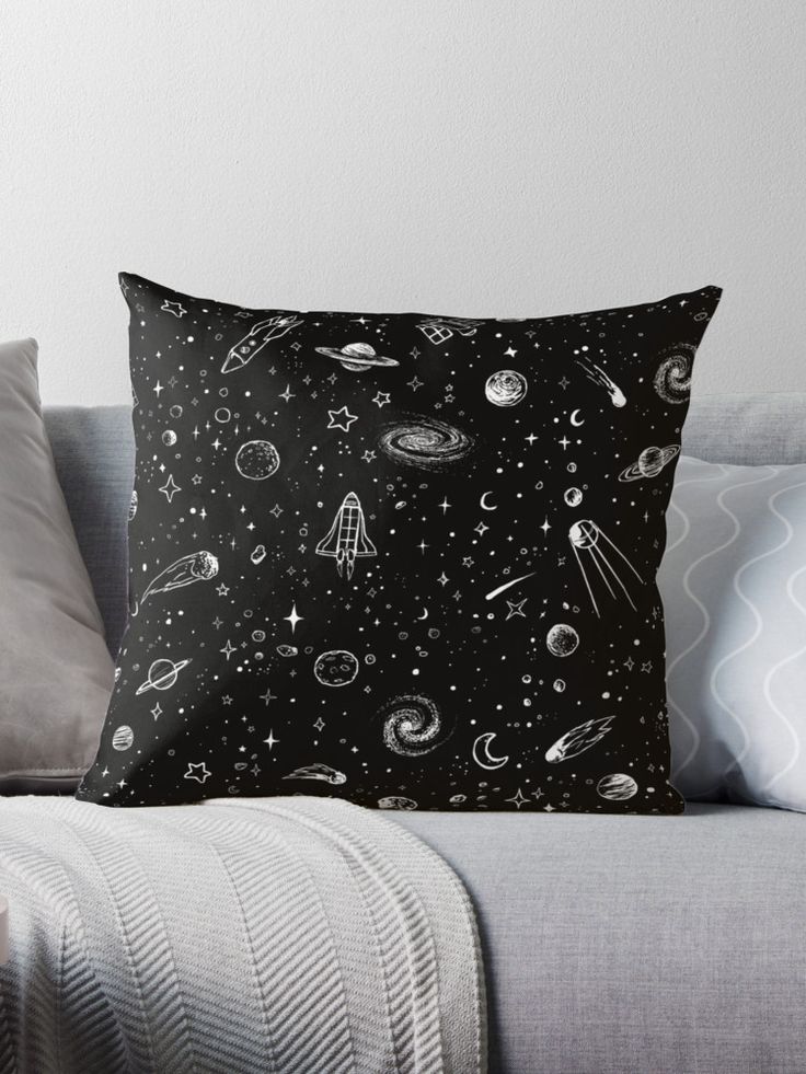 a black and white throw pillow sitting on top of a couch