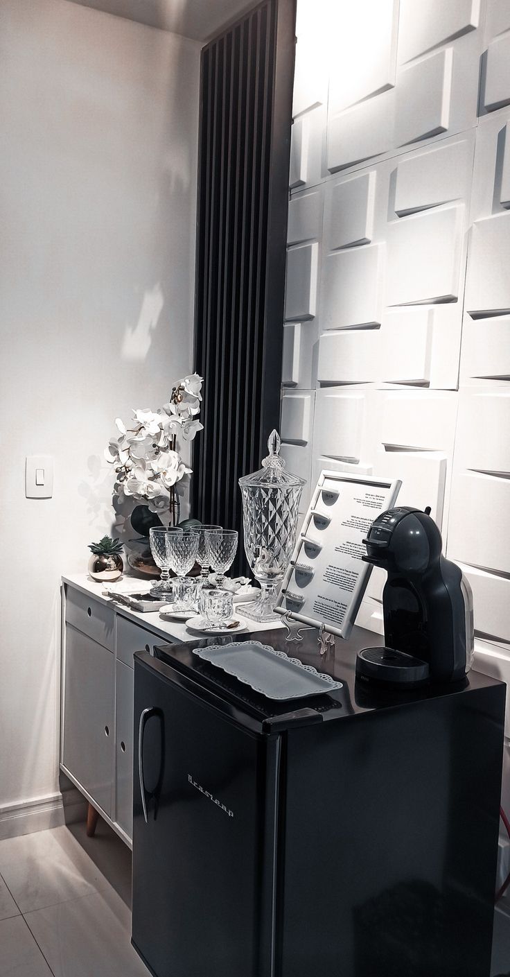 a black refrigerator freezer sitting on top of a counter