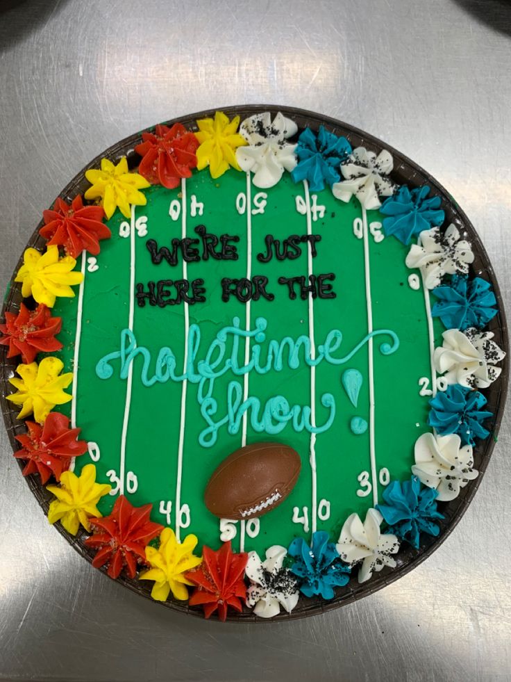 a football themed cake with flowers on it