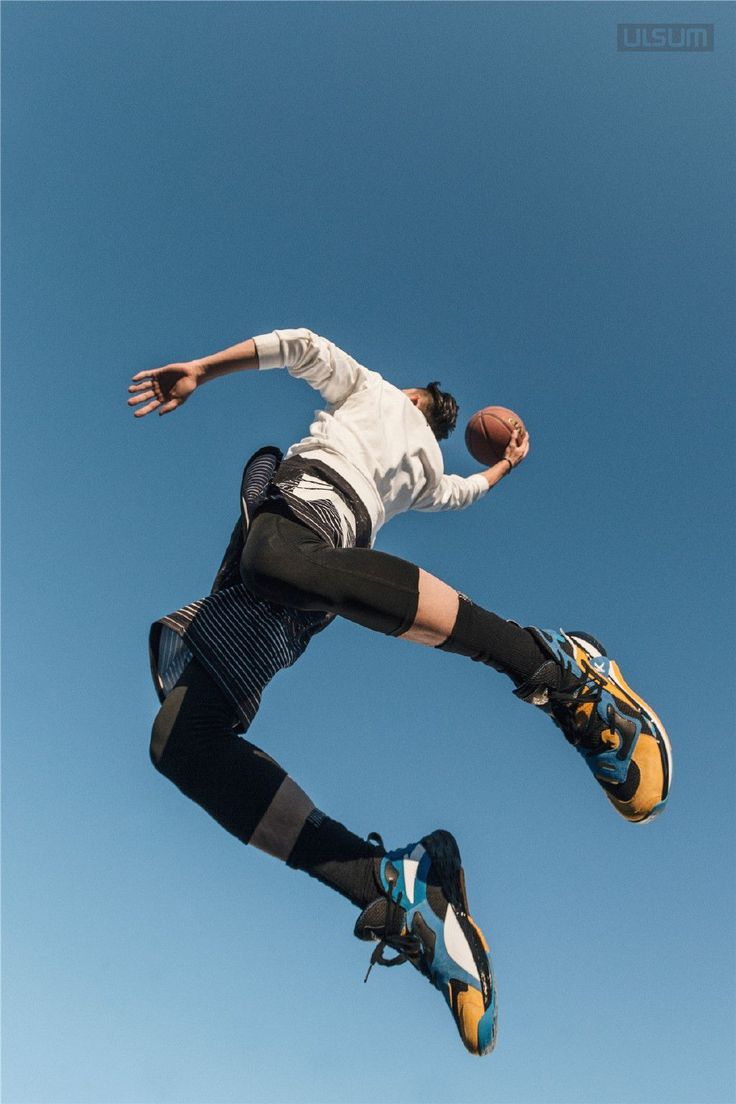 a man flying through the air while riding a skateboard in front of a blue sky