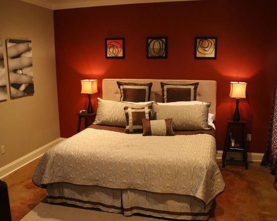 a bedroom with red walls and white bedding