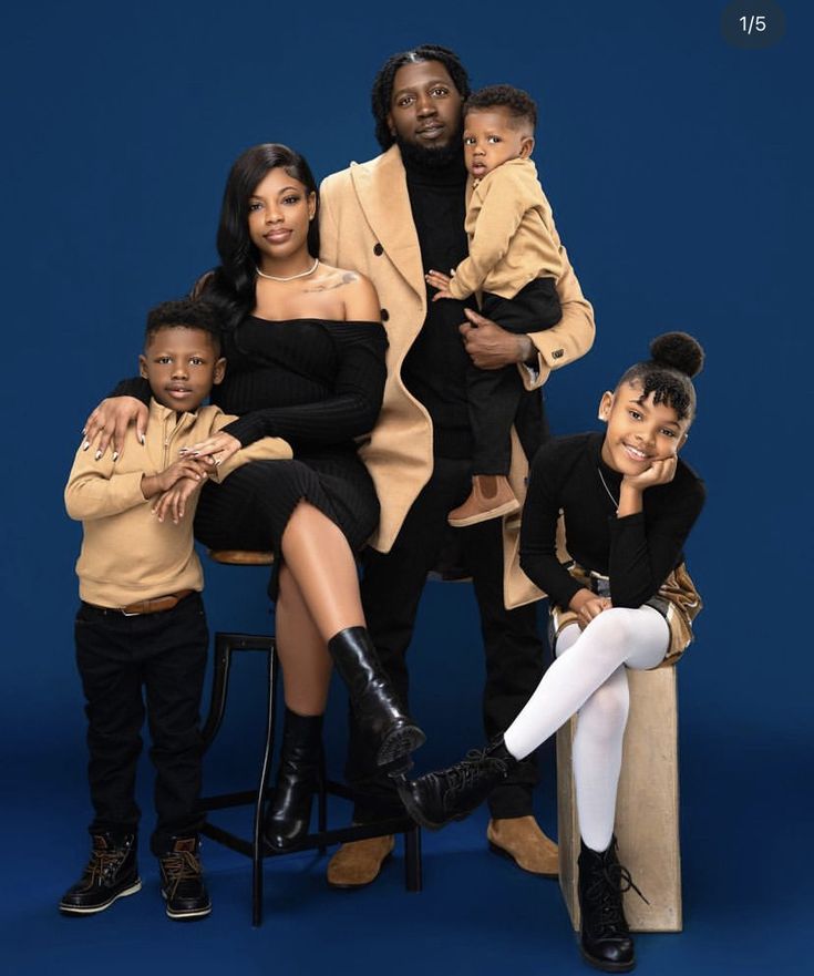 a family posing for a photo in front of a blue background