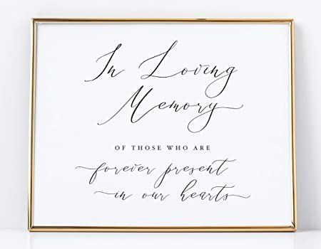 a framed wedding guest sign with the words in loving memory on it's side