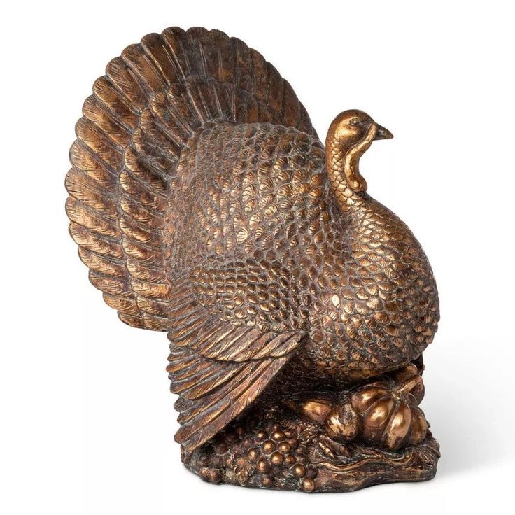 a bronze figurine of a turkey on a white background