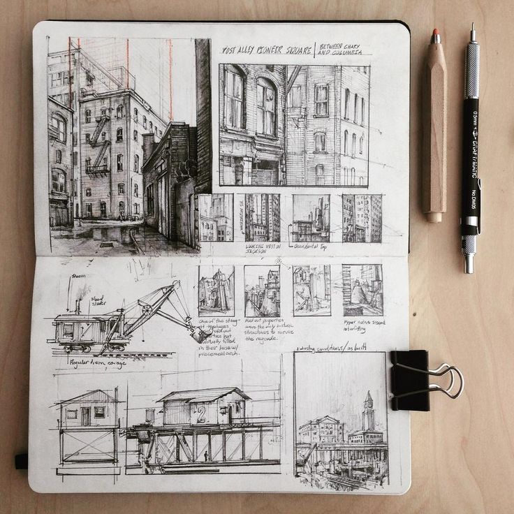 a notebook with some drawings on it and a pen in front of the pages that have been drawn