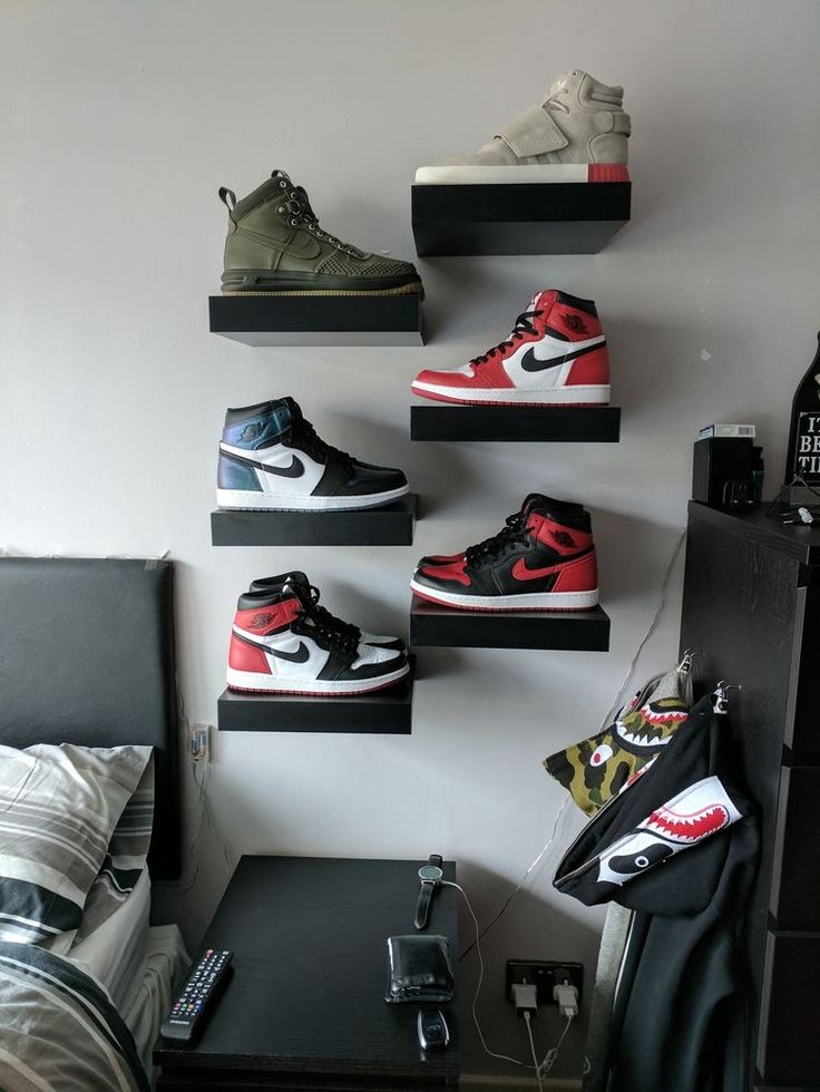 there are many pairs of shoes hanging on the wall