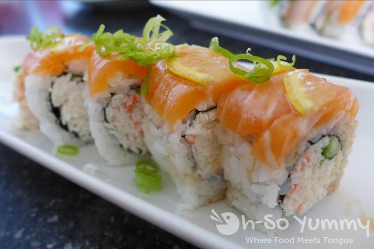 sushi with sauce and garnish on a white plate